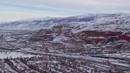 5.5K aerial stock footage orbit Interstate 15 and train tracks by snowy mountains at sunrise in Salt Lake City, Utah Aerial Stock Footage | AX124_231