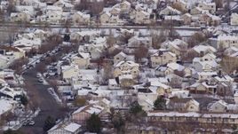 5.5K aerial stock footage orbit Salt Lake City tract homes with snowy rooftops at sunrise, Utah Aerial Stock Footage | AX124_233
