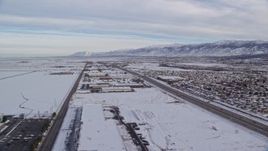 5.5K aerial stock footage of warehouse buildings in snowy Salt Lake City at sunrise in Utah Aerial Stock Footage | AX124_234