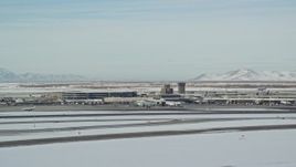 5.5K aerial stock footage of Salt Lake City International Airport revealing commercial jet in winter, Utah Aerial Stock Footage | AX125_001E