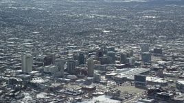 5.5K aerial stock footage tilt from freeway to reveal Downtown Salt Lake City with winter snow, Utah Aerial Stock Footage | AX125_006E
