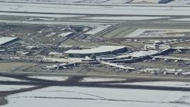 5.5K aerial stock footage of Salt Lake City International Airport terminals with winter snowing Utah Aerial Stock Footage | AX125_009
