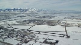 5.5K aerial stock footage of Salt Lake City International Airport and jet on runway with winter snow in Utah Aerial Stock Footage | AX125_010