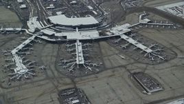 5.5K aerial stock footage orbit Salt Lake City International Airport terminals with airliners and winter snow, Utah Aerial Stock Footage | AX125_015