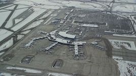 5.5K aerial stock footage of orbiting SLC Airport terminals and parking lots with winter snow in Utah Aerial Stock Footage | AX125_016