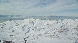 5.5K aerial stock footage of snowy Antelope Island mountains in wintertime Utah Aerial Stock Footage | AX125_033E