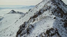 5.5K aerial stock footage circle a snowy peak to reveal bighorn sheep on Antelope Island, Utah Aerial Stock Footage | AX125_065