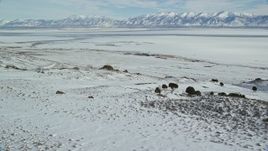5.5K aerial stock footage orbit sheets of ice on the Great Salt Lake seen from Antelope Island, Utah Aerial Stock Footage | AX125_085