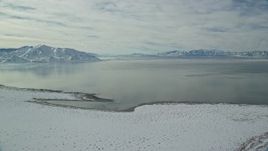 5.5K aerial stock footage of the Great Salt Lake seen from Antelope Island in winter, Utah Aerial Stock Footage | AX125_099