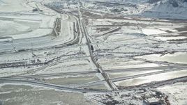 5.5K aerial stock footage orbit Interstate 80 through frozen countryside near Magna, Utah Aerial Stock Footage | AX125_107