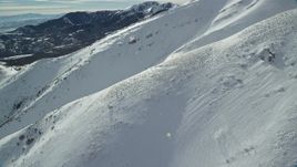 5.5K aerial stock footage flyby thick snow on Kessler Peak slopes in winter, Utah Aerial Stock Footage | AX125_128