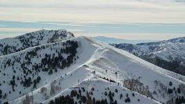 5.5K aerial stock footage of snowy mountain peak summits in winter in the Oquirrh Mountains, Utah Aerial Stock Footage | AX125_142