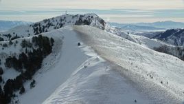 5.5K aerial stock footage fly over snowy mountain slope to approach Nelson Peak in winter, Utah Aerial Stock Footage | AX125_144