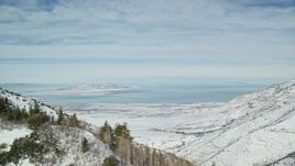 5.5K aerial stock footage of Great Salt Lake seen from trees in the Oquirrh Mountains, Utah Aerial Stock Footage | AX125_155E