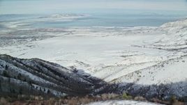 5.5K aerial stock footage of Great Salt Lake seen from wintery mountains in Utah Aerial Stock Footage | AX125_159