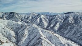 5.5K aerial stock footage of light snow on Oquirrh Mountains in wintertime Utah Aerial Stock Footage | AX125_164