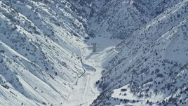 5.5K aerial stock footage of lone building in the Oquirrh Mountains with winter snow, Utah Aerial Stock Footage | AX125_165