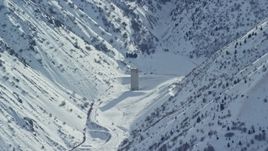 5.5K aerial stock footage of Baltimore Gulch with lone building in the Oquirrh Mountains with snow, Utah Aerial Stock Footage | AX125_167