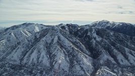 5.5K aerial stock footage of slowly passing by Oquirrh Mountains with winter snow in Utah Aerial Stock Footage | AX125_169E
