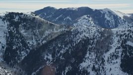 5.5K aerial stock footage of a Oquirrh Mountains ridge with snowdrifts in winter, Utah Aerial Stock Footage | AX125_171E