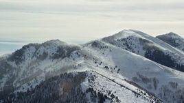 5.5K aerial stock footage of snowdrifts on peaks in the Oquirrh Mountains, Utah Aerial Stock Footage | AX125_183E
