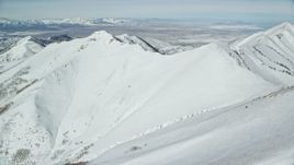 5.5K aerial stock footage of snowy slopes in the Oquirrh Mountains of Utah in winter Aerial Stock Footage | AX125_212