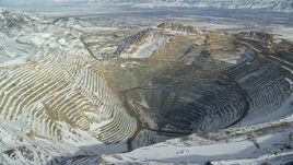 5.5K aerial stock footage of the Bingham Canyon Mine in winter with light snow in Utah Aerial Stock Footage | AX125_229E