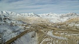 5.5K aerial stock footage of Bingham Canyon open pit copper mine with winter snow in Utah Aerial Stock Footage | AX125_247