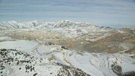 5.5K aerial stock footage of Bingham Canyon Mine with winter snow in Utah Aerial Stock Footage | AX125_254E