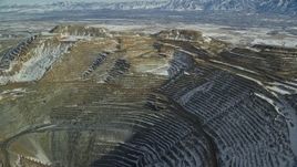 5.5K aerial stock footage of orbiting the sides of the Bingham Canyon Mine with light snow, Utah Aerial Stock Footage | AX125_264