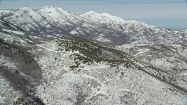 5.5K aerial stock footage of snowy Farnsworth and Kessler Peaks seen from smaller peaks in winter, Utah Aerial Stock Footage | AX125_278E