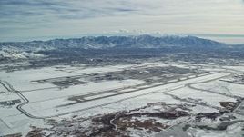 5.5K aerial stock footage of Salt Lake City International Airport in Utah with winter snow Aerial Stock Footage | AX125_324