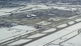 5.5K aerial stock footage of tracking commercial jet on runway at SLC Airport with winter snow Aerial Stock Footage | AX125_325E