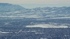 5.5K aerial stock footage track airliner soaring over Salt Lake City in winter, Utah Aerial Stock Footage | AX125_328E