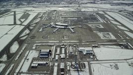 5.5K aerial stock footage of control tower and terminals at Salt Lake City International Airport with winter snow, Utah Aerial Stock Footage | AX125_330E