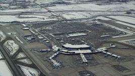 5.5K aerial stock footage orbit terminals and parking lot at Salt Lake City Airport with winter snow, Utah Aerial Stock Footage | AX125_332