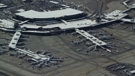 5.5K aerial stock footage orbit airliners at the airport terminal of Salt Lake City Airport with winter snow, Utah Aerial Stock Footage | AX125_333