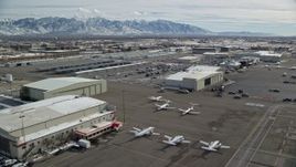 5.5K aerial stock footage of hangars and private planes at Salt Lake City Airport in winter, Utah Aerial Stock Footage | AX126_001