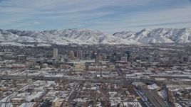 5.5K aerial stock footage of downtown area of Salt Lake City and snowy mountains in winter, Utah Aerial Stock Footage | AX126_007