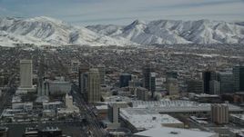 5.5K aerial stock footage orbit convention center and Downtown Salt Lake City buildings with winter snow, Utah Aerial Stock Footage | AX126_031