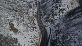5.5K aerial stock footage of a bird's eye of light traffic rounding a bend in Interstate 80 through Wasatch Range, Utah Aerial Stock Footage | AX126_072E