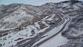 5.5K aerial stock footage approach freeway through snowy mountain pass in winter, Utah Aerial Stock Footage | AX126_077E