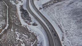 5.5K aerial stock footage bird's eye view of light traffic on mountain pass freeway in winter, Wasatch Range, Utah Aerial Stock Footage | AX126_083