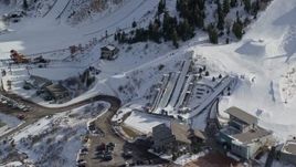 5.5K aerial stock footage orbit the aerials pool at Utah Olympic Park with winter snow, Park City Aerial Stock Footage | AX126_106