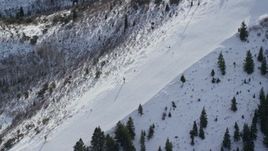 5.5K aerial stock footage of bird's eye view of skiers on a slope at Canyons Resort in Park City, Utah Aerial Stock Footage | AX126_112