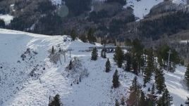 5.5K aerial stock footage orbit gondolas at the summit of a snowy mountain in winter, Park City, Utah Aerial Stock Footage | AX126_121E