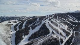 5.5K aerial stock footage orbiting snowy ski runs and lift at Park City Mountain Resort in winter, Utah Aerial Stock Footage | AX126_123