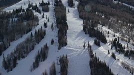 5.5K aerial stock footage orbit ski lift and skiers at Park City Mountain Resort in winter, Utah Aerial Stock Footage | AX126_125