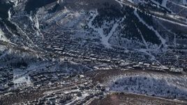 5.5K aerial stock footage orbit small town in winter shaded by snowy mountain, Park City, Utah Aerial Stock Footage | AX126_150