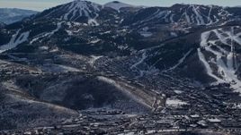 5.5K aerial stock footage a small mountain town at the base of snowy peak in winter, Park City, Utah Aerial Stock Footage | AX126_156E